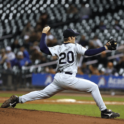 Baseball pitcher in mid-throw on a pitcher's mound