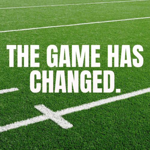 Synthetic turf football field with 'THE GAME HAS CHANGED' text, representing the evolution of football from natural grass to artificial surfaces